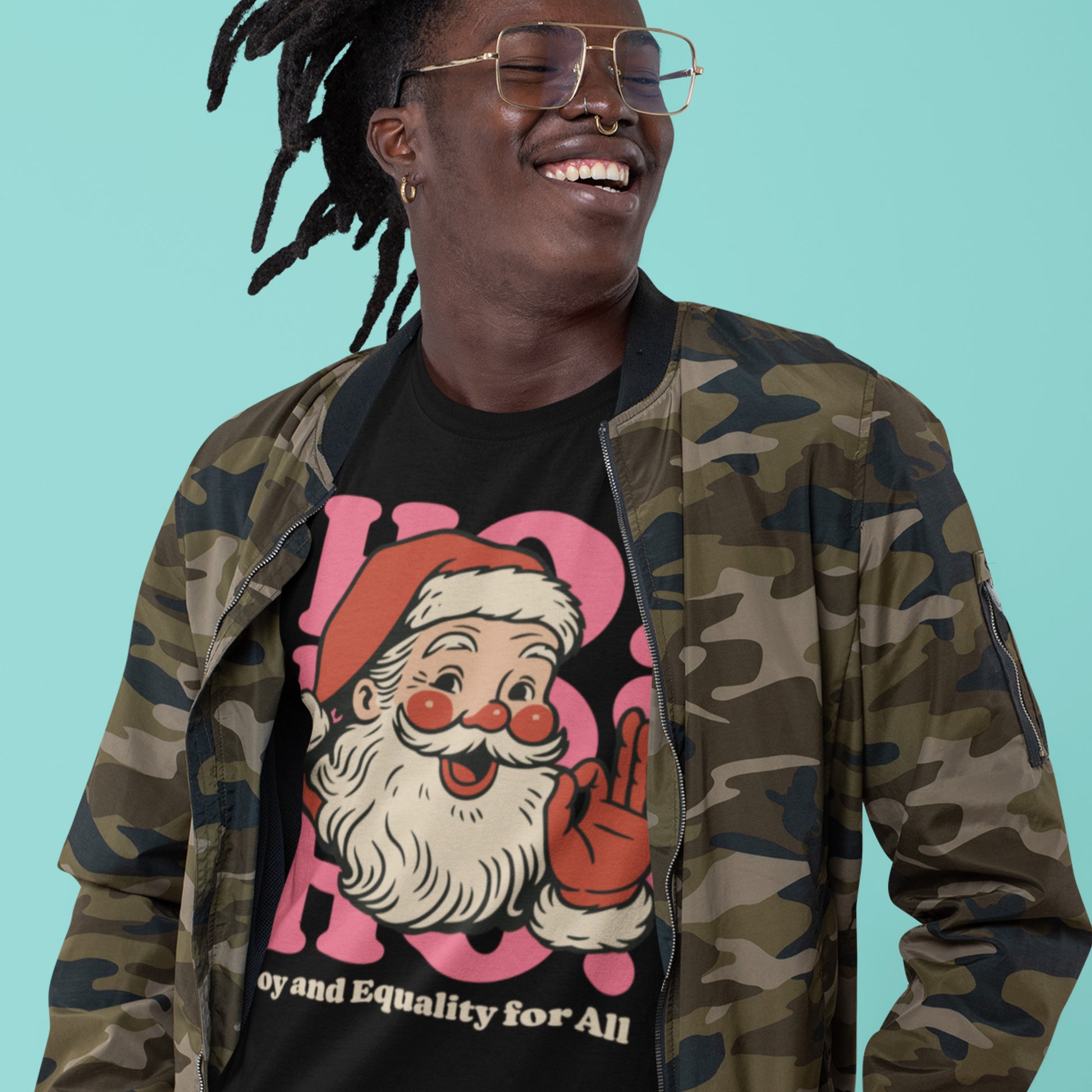 Person smiling while wearing the progressive Christmas t-shirt with the vintage Santa graphic and “Joy and Equality for All” message—an inclusive holiday style from Blue Wave USA.
