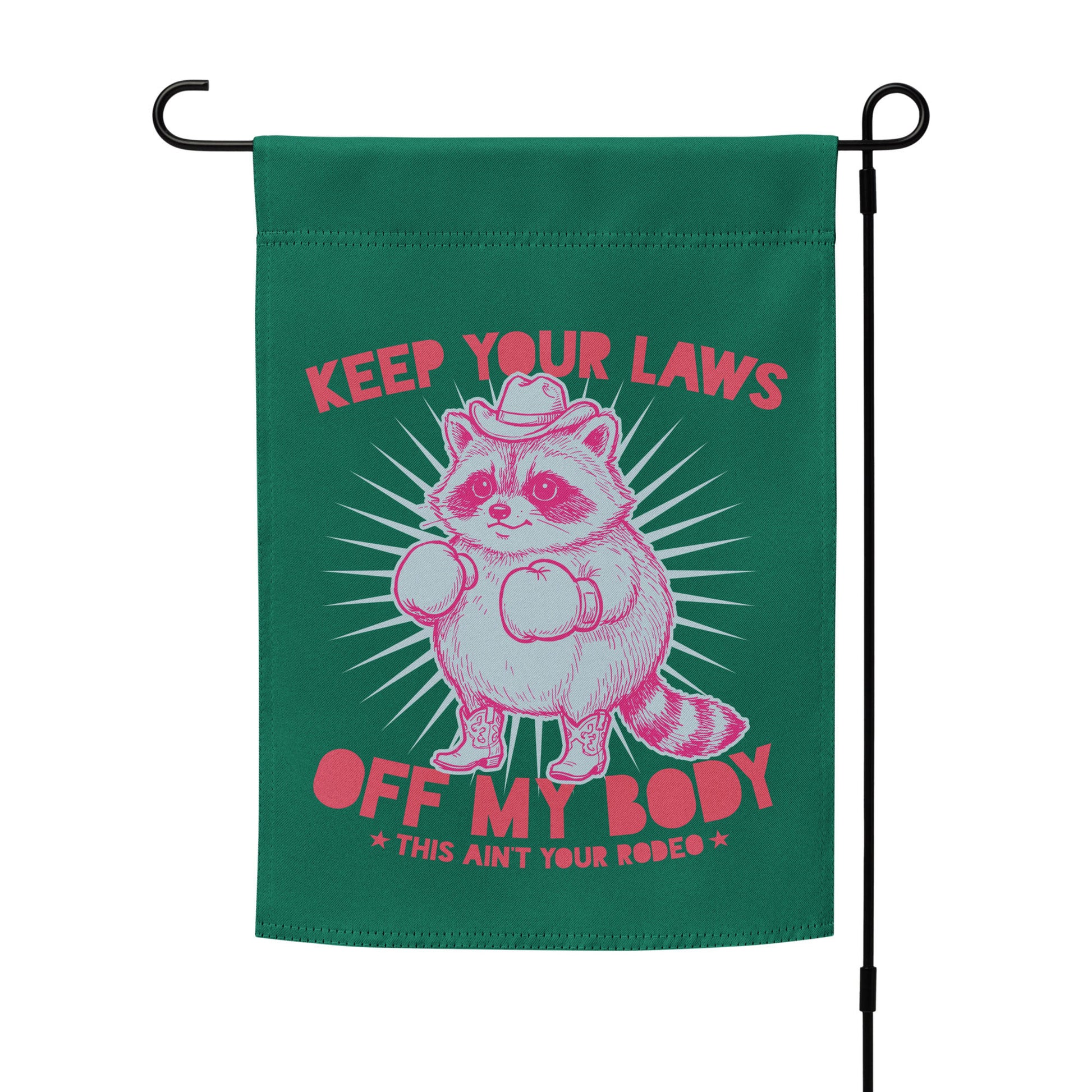 Garden flag mockup on stand featuring cowboy raccoon graphic and reproductive rights slogan in bold western feminist outdoor decor style.