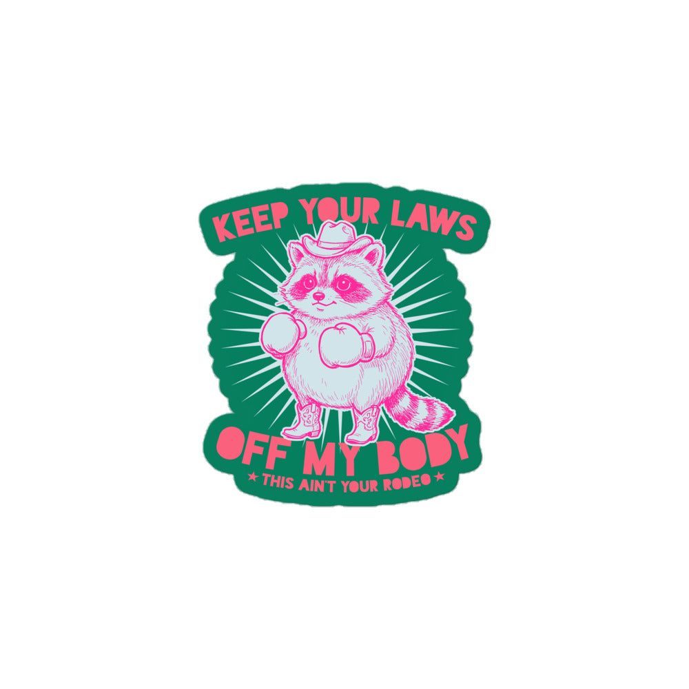 Small die-cut sticker featuring cowboy raccoon graphic with “Off My Body” phrase and “This Ain’t Your Rodeo” text in bold feminist design.