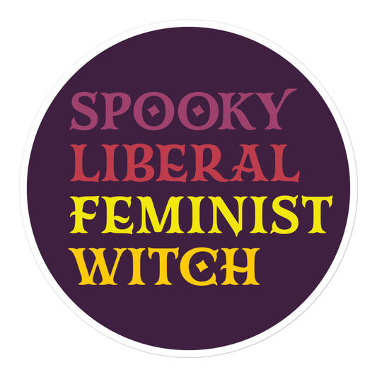 Round sticker featuring retro serif typography reading “SPOOKY LIBERAL FEMINIST WITCH” in pink and yellow lettering on a deep purple background with clean circular layout and bold graphic style.