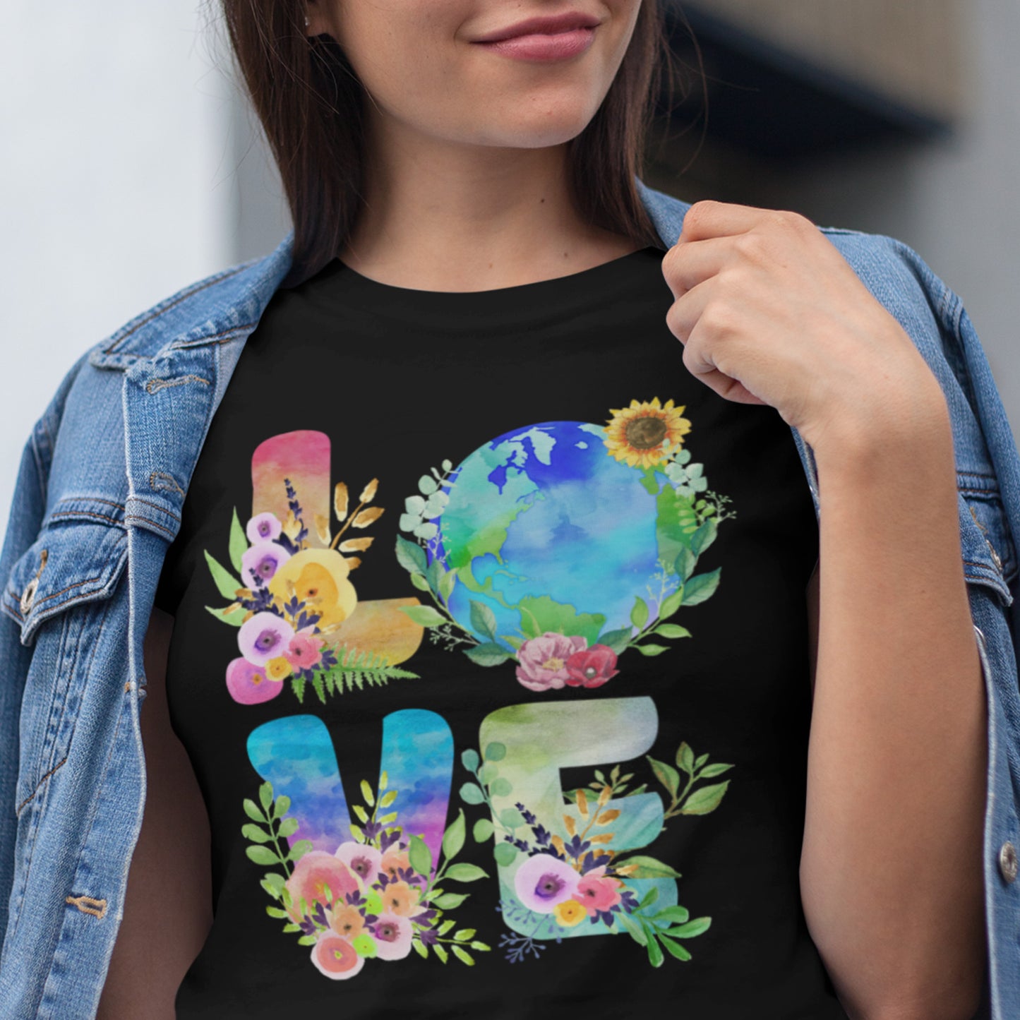 Eco-conscious “LOVE” Earth Day t-shirt with floral planet design styled under denim jacket.