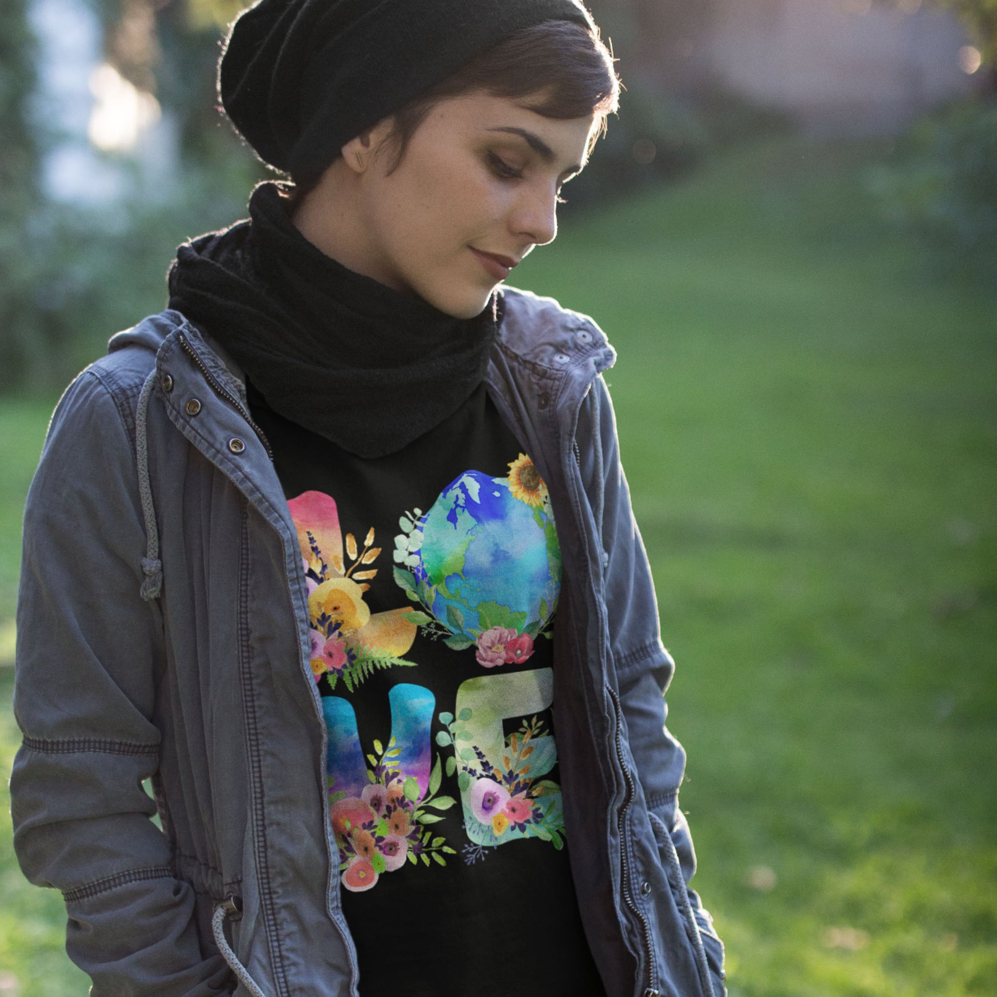 Model wearing “LOVE Earth Floral” t-shirt with globe and flower illustration, progressive activist style.