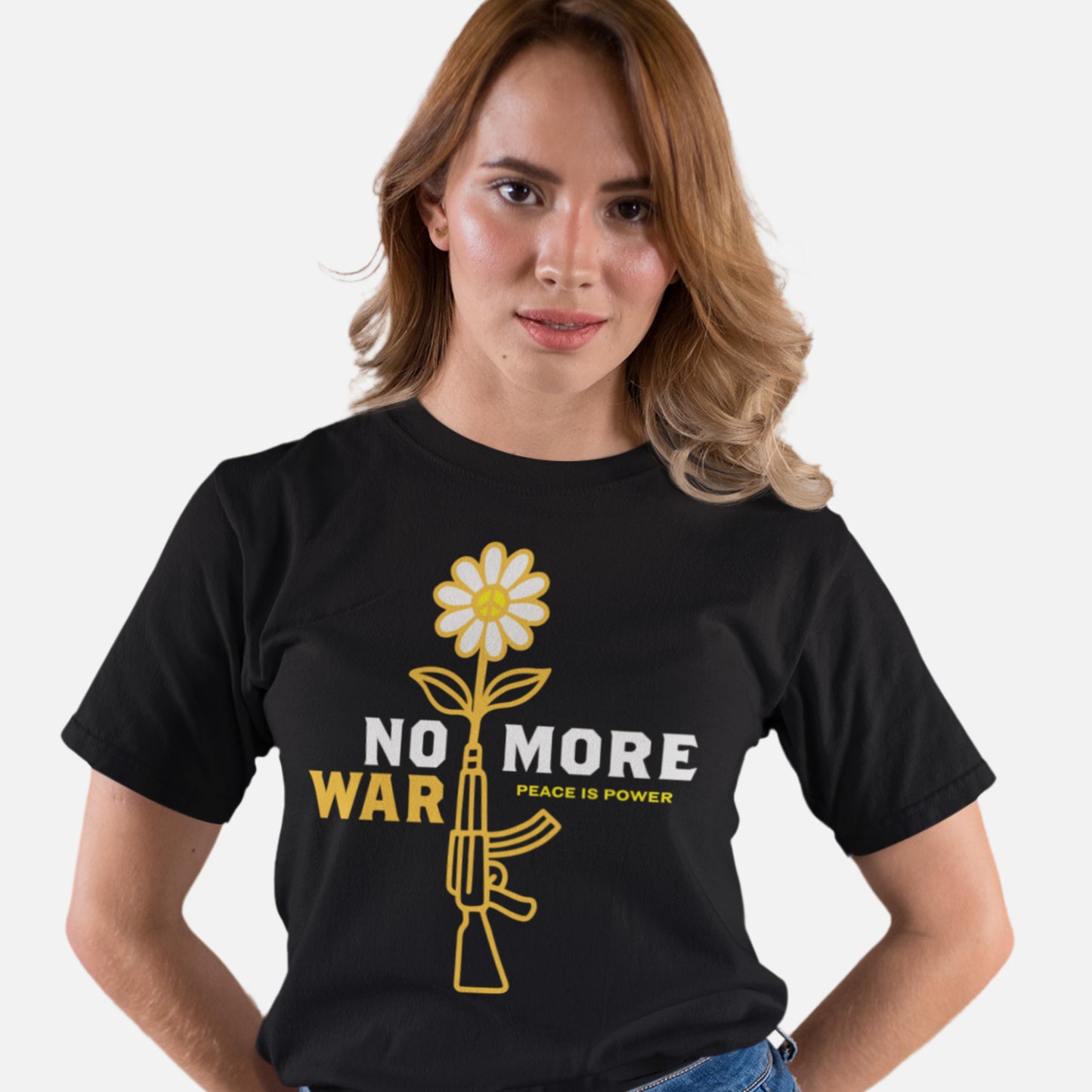 Model wearing black women’s relaxed t-shirt displaying daisy-and-rifle illustration with “NO MORE WAR” slogan in clean, modern layout.