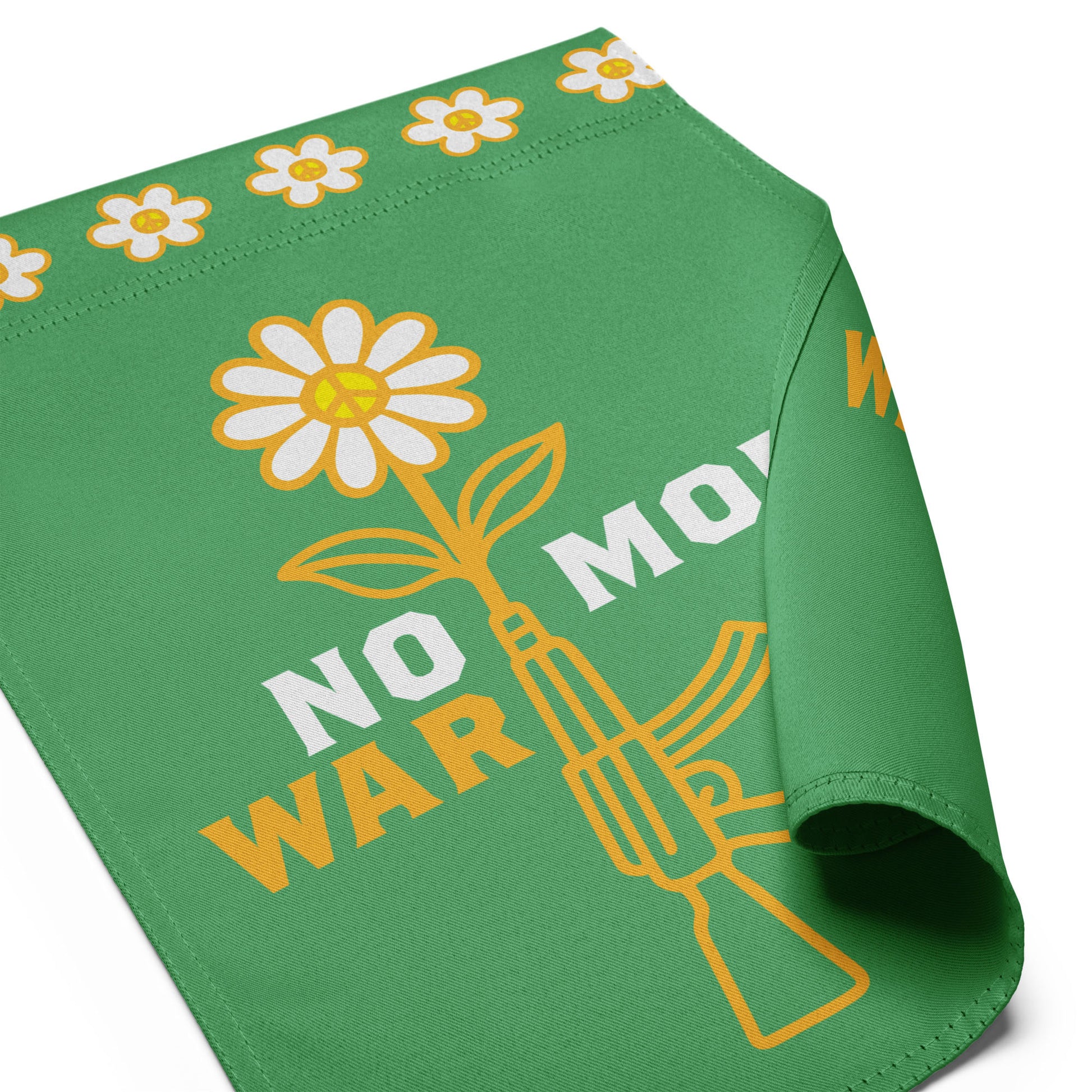 Angled view of garden flag showing flower blooming from rifle barrel with bold peace-forward wording across front panel.