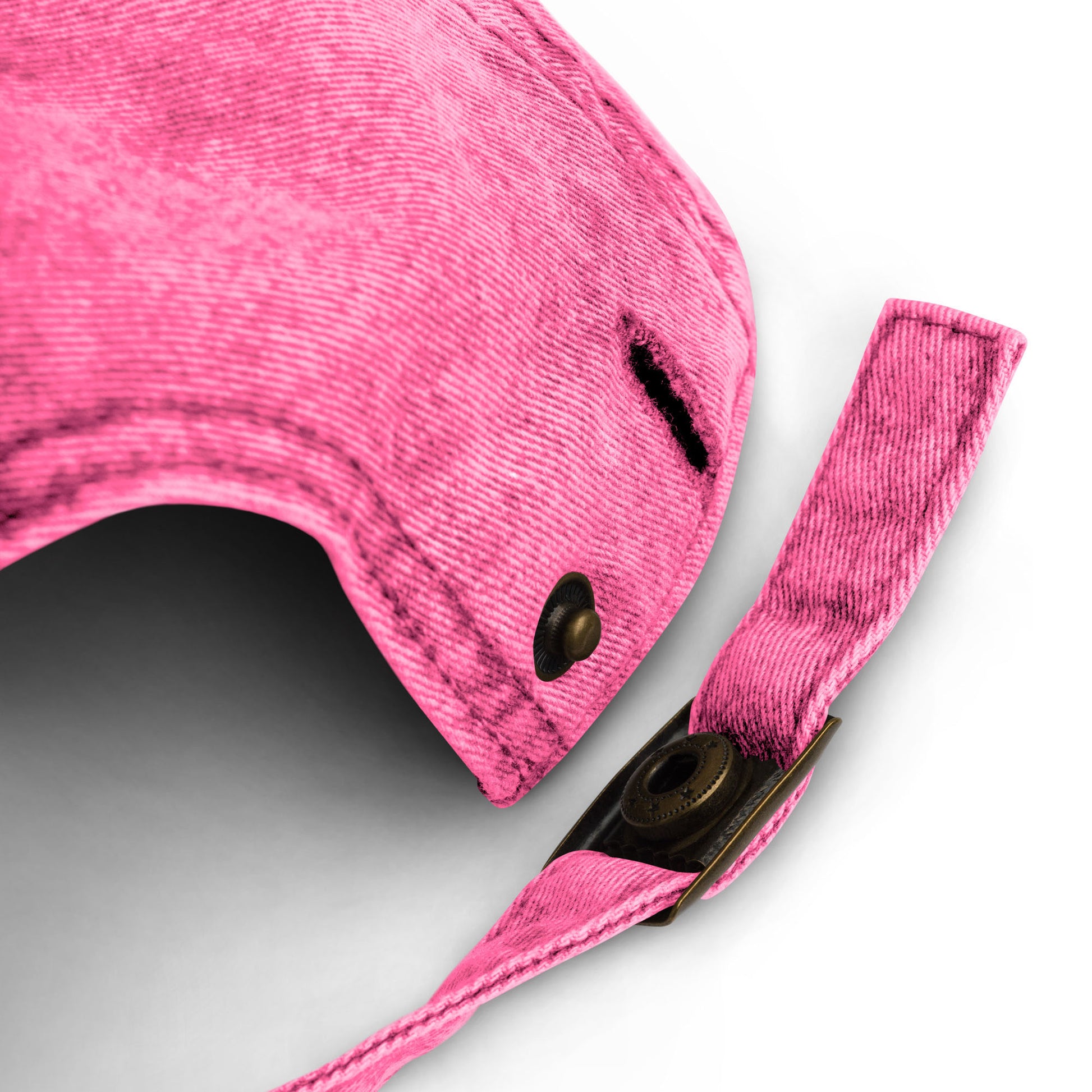 Close-up of the pink vintage cap showing the adjustable fabric strap, metal buckle, and garment-washed finish.