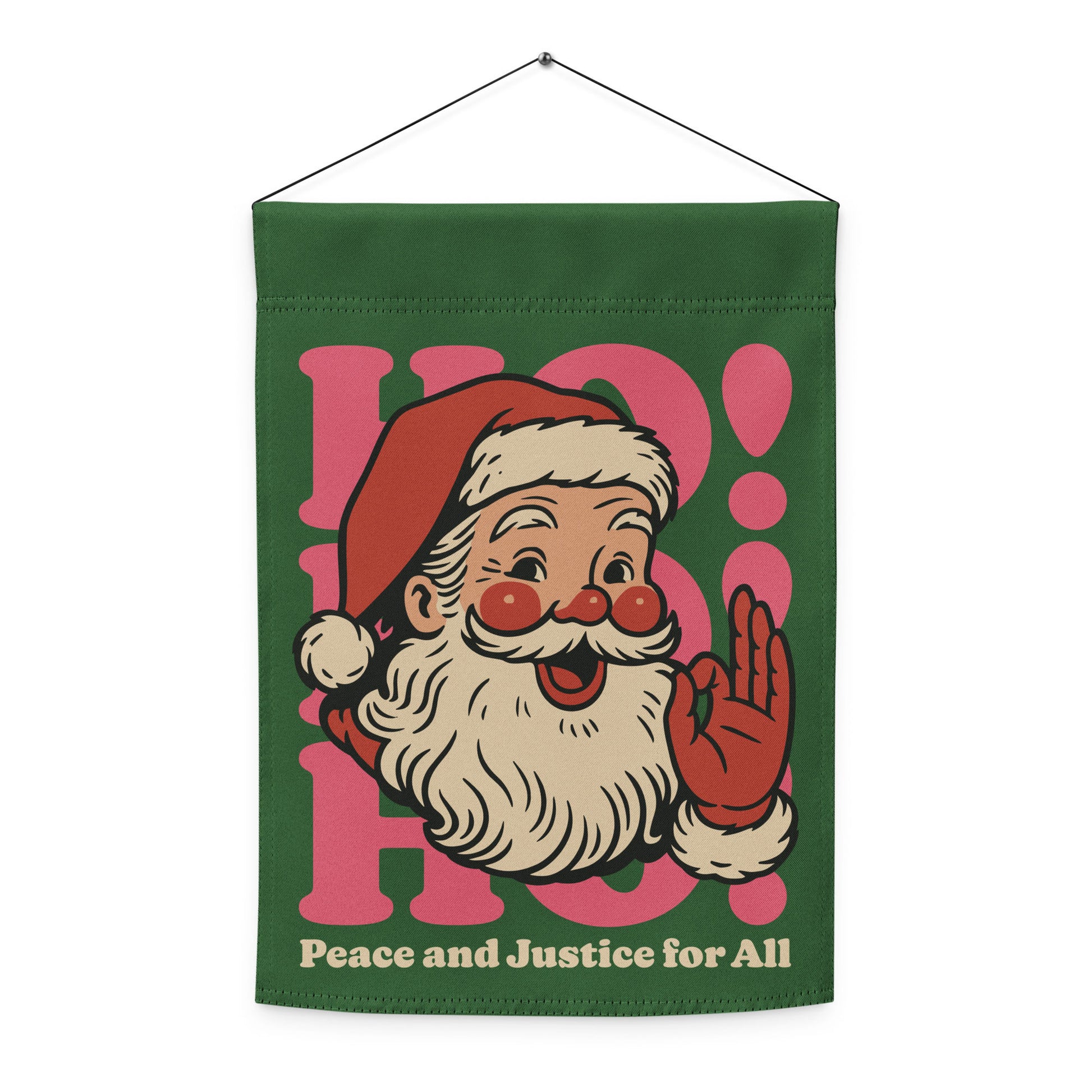 Green hanging garden flag with a retro Santa illustration, pink “HO!” typography, and the printed phrase “Peace and Justice for All.”