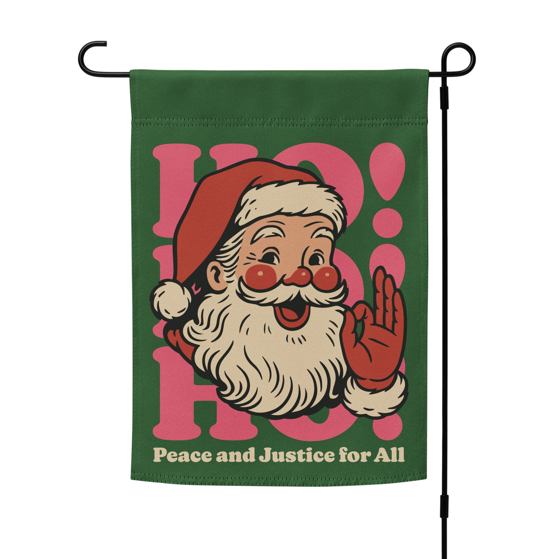 Green garden flag on a metal stand, printed with a vintage-style Santa illustration, pink “HO!” block lettering, and the message “Peace and Justice for All,” designed by Blue Wave USA.