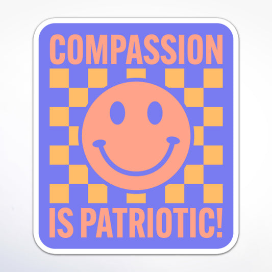 Progressive activism sticker with a happy face, yellow and purple checkerboard, and the message “Compassion is Patriotic!” in a bold font.