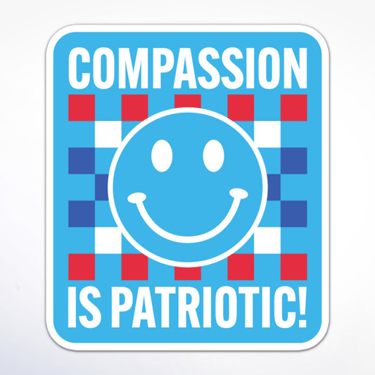 Social justice sticker with a blue smiley face, checkered pattern, and patriotic colors, displaying the message “Compassion is Patriotic!” in white block text.