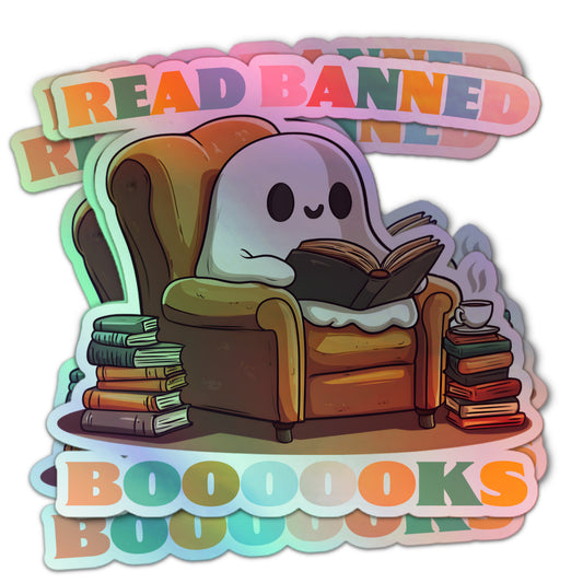 Holographic sticker of a cute ghost sitting in an armchair, reading a book, with the text “Read Banned Boooooks” in colorful letters and stacks of books nearby.