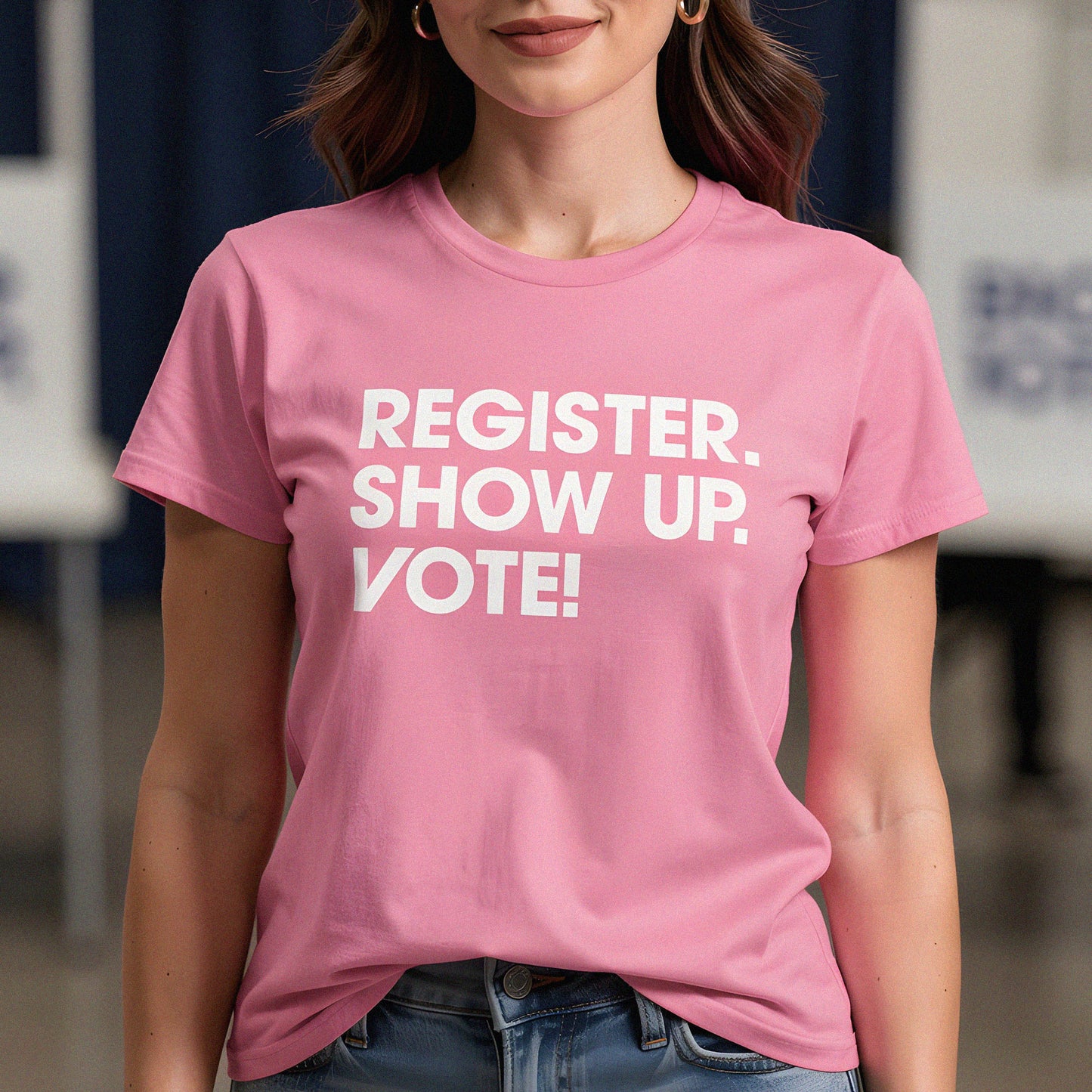 Woman wearing pink voting rights t-shirt with bold white “Register. Show Up. Vote!” slogan promoting civic engagement, voter participation, and democratic action.