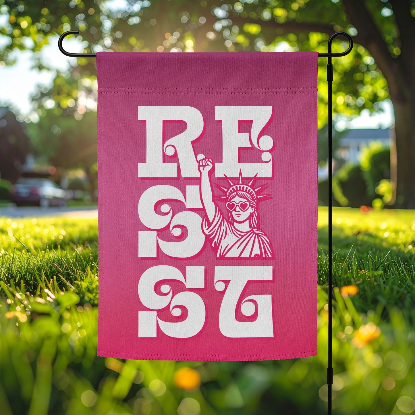 Pink garden flag featuring bold white vertical “RESIST” typography with Statue of Liberty illustration, feminist activism outdoor decor for justice-focused yard display.