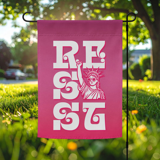 Pink garden flag featuring bold white vertical “RESIST” typography with Statue of Liberty illustration, feminist activism outdoor decor for justice-focused yard display.