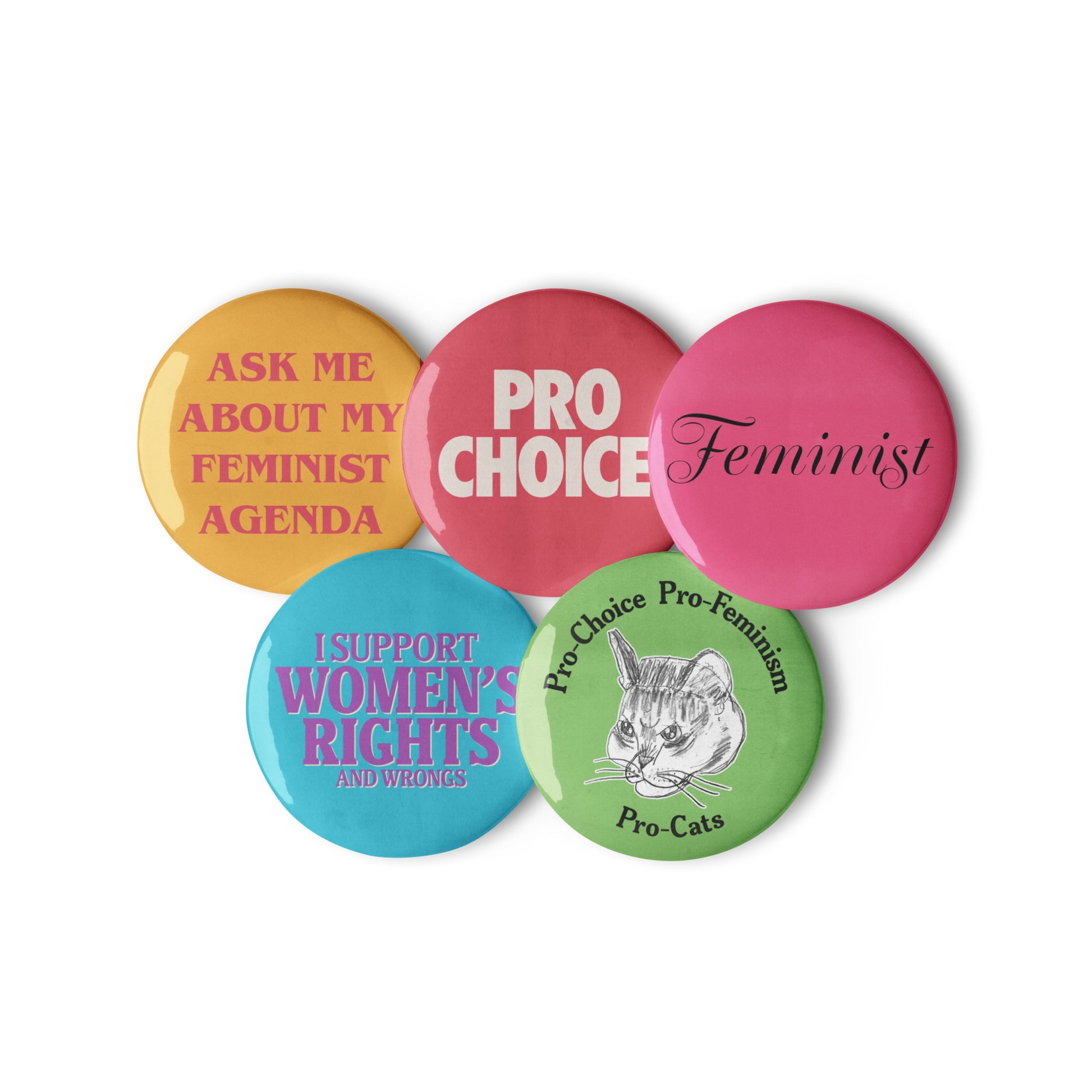 Set of five colorful feminist pin buttons reading “Ask Me About My Feminist Agenda,” “Pro Choice,” “Feminist,” “I Support Women’s Rights and Wrongs,” and “Pro-Choice Pro-Feminism Pro-Cats.” Vintage-inspired activism pins by Blue Wave USA.