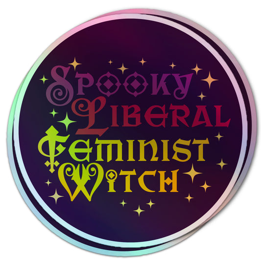 Sparkly round sticker reading “Spooky Liberal Feminist Witch” in a gothic font, accented with stars and a holographic finish.