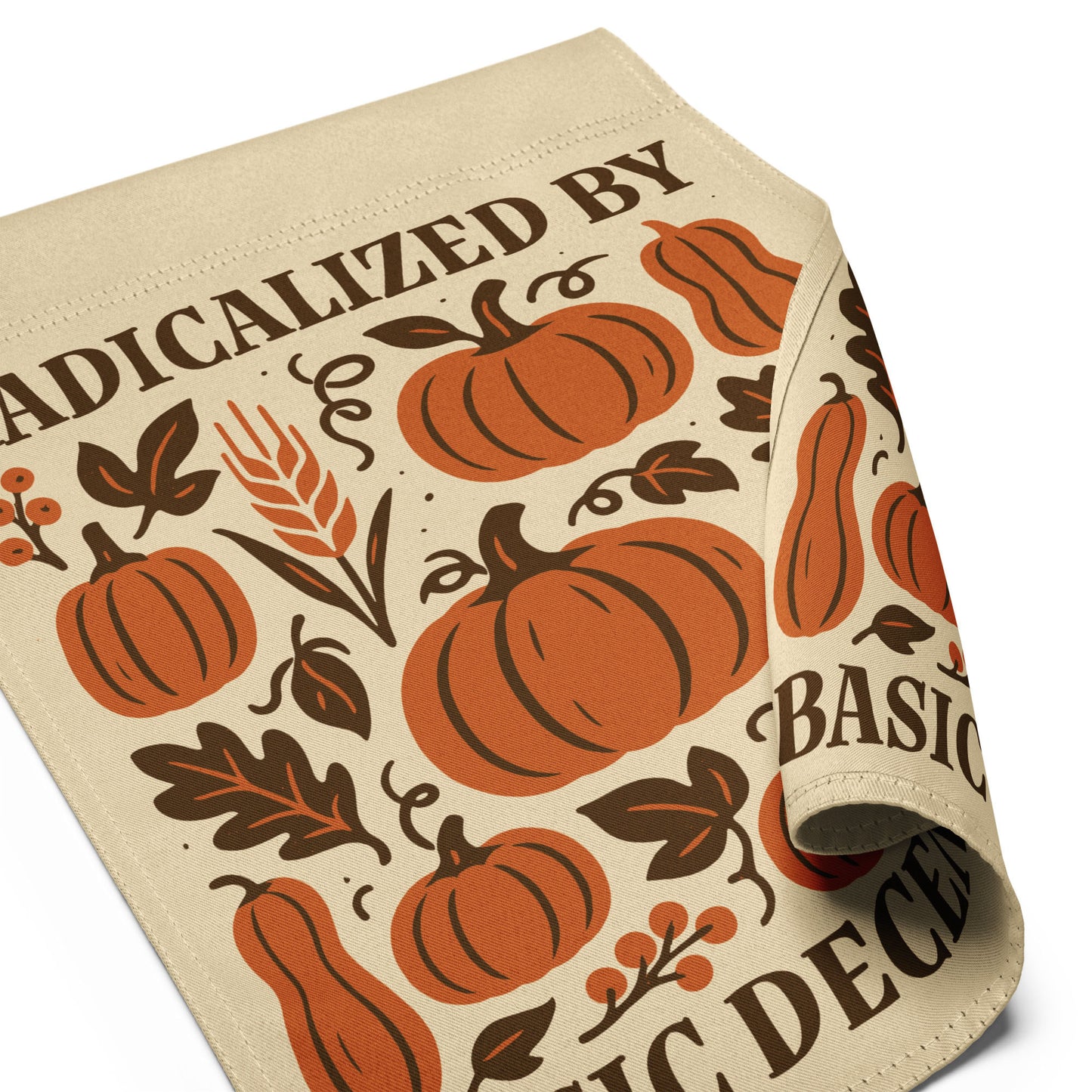 Close-up angled view of garden flag with orange pumpkins and “Radicalized by Basic Decency” text in autumn-inspired Thanksgiving design.