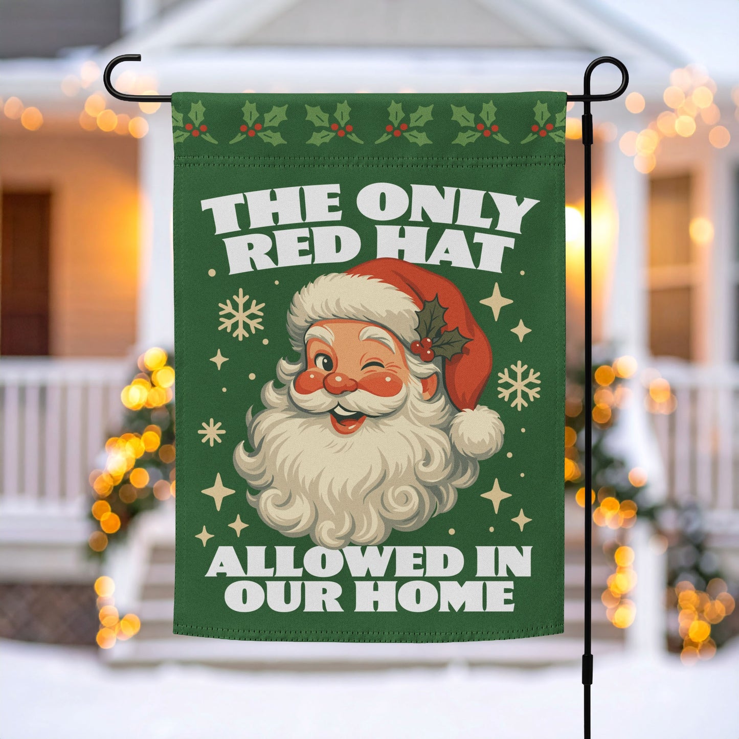 Green garden flag on a metal stand with a retro Santa illustration, holiday motifs, and the printed message “THE ONLY RED HAT ALLOWED IN OUR HOME,” outdoor décor by Blue Wave USA.