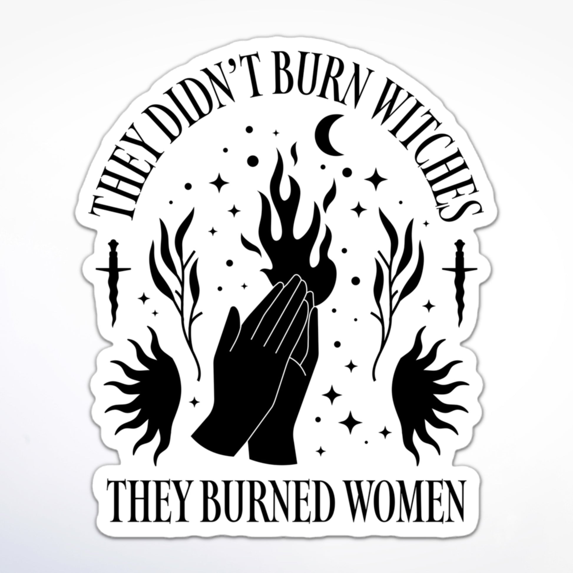 Feminist sticker with witchy iconography—hands, fire, moon, and daggers—paired with “They Didn’t Burn Witches, They Burned Women.”