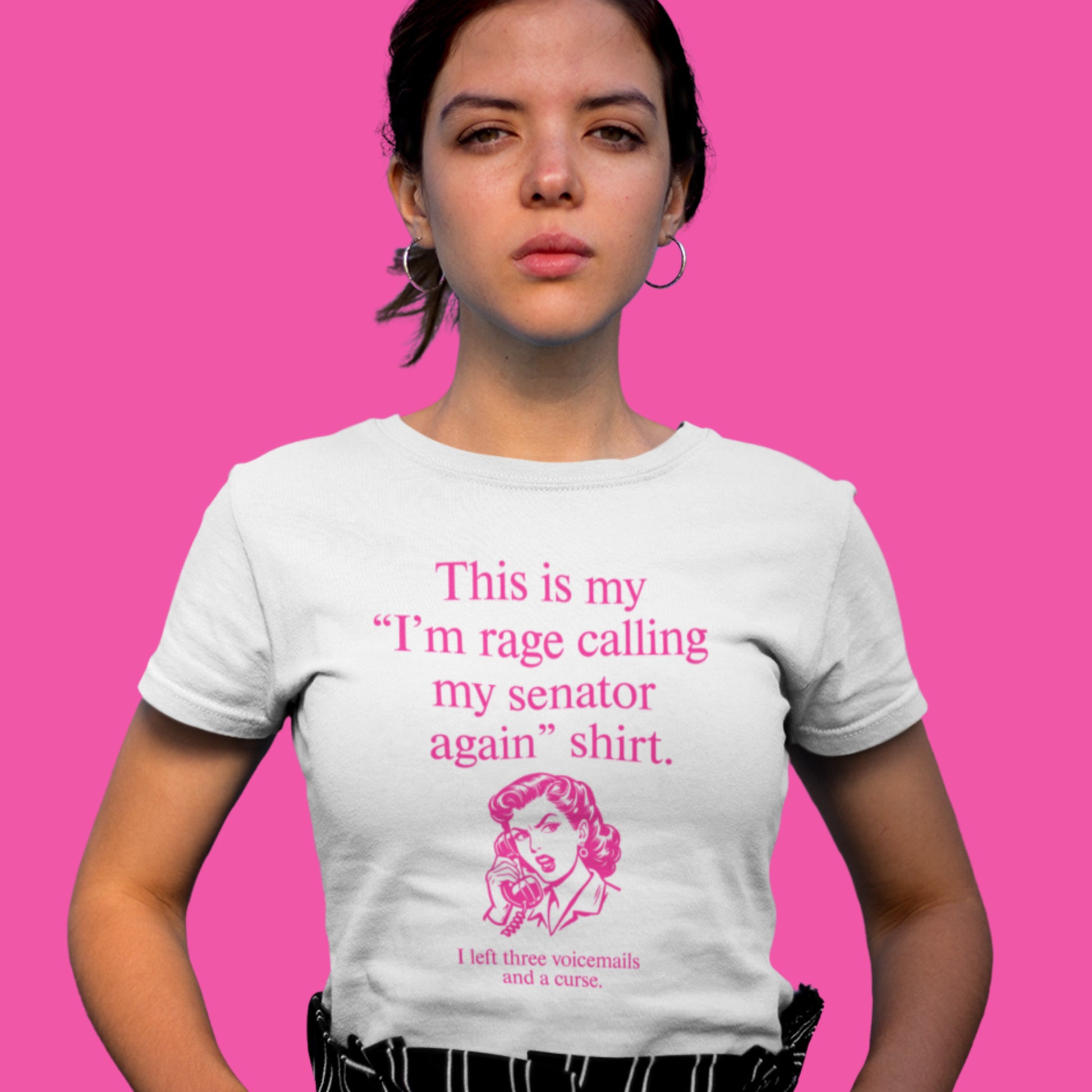 Model wearing white women’s relaxed t-shirt displaying pink text reading “This is my ‘I’m rage calling my senator again’ shirt.”