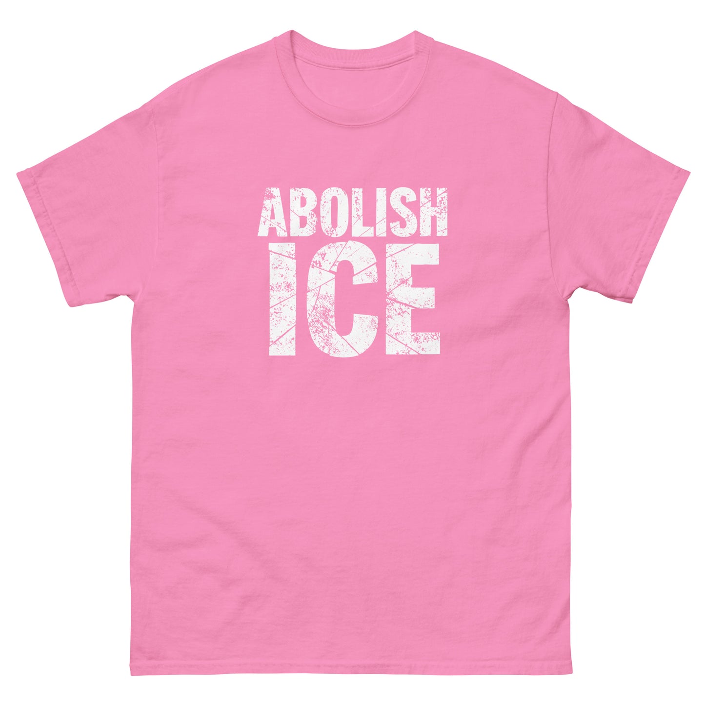 Soft pink unisex classic t-shirt with distressed white block text in a compact protest design, high-contrast lettering with a rough, weathered finish.
