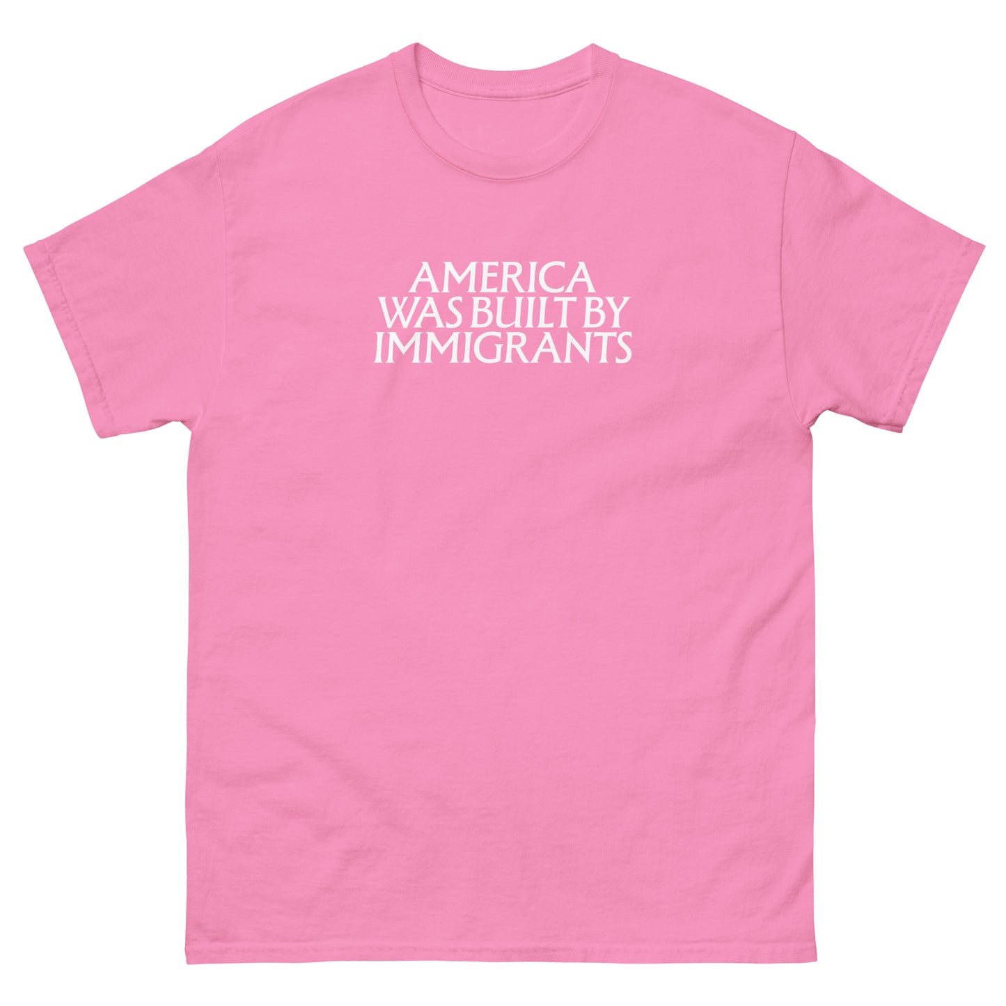 Pink unisex embroidered t-shirt with small white chest text in a clean serif font, minimalist pro-immigrant message stitched on soft fabric.