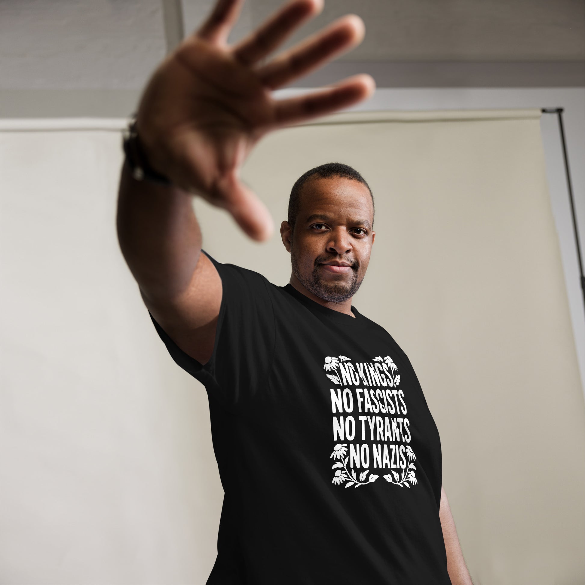 Lifestyle Image: Black activist wearing No Kings No Fascists No Tyrants No Nazis” shirt 