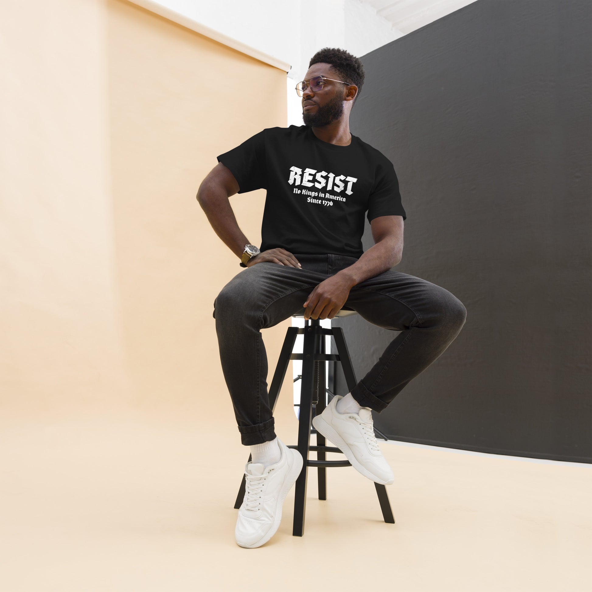 Lifestyle Image: Black Male Protester wearing “RESIST – No Kings In America Since 1776” protest shirt 