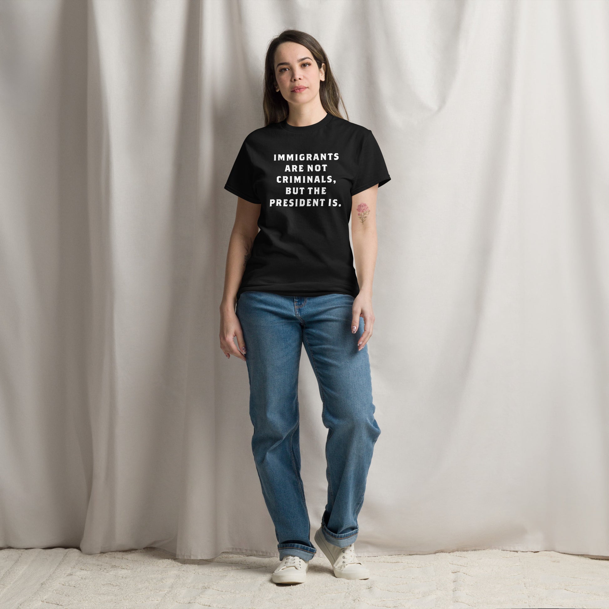 Female Model wearing the "Immigrants Are Not Criminals" Anti-Trump Anti-ICE tee, making a powerful statement for human rights & accountability