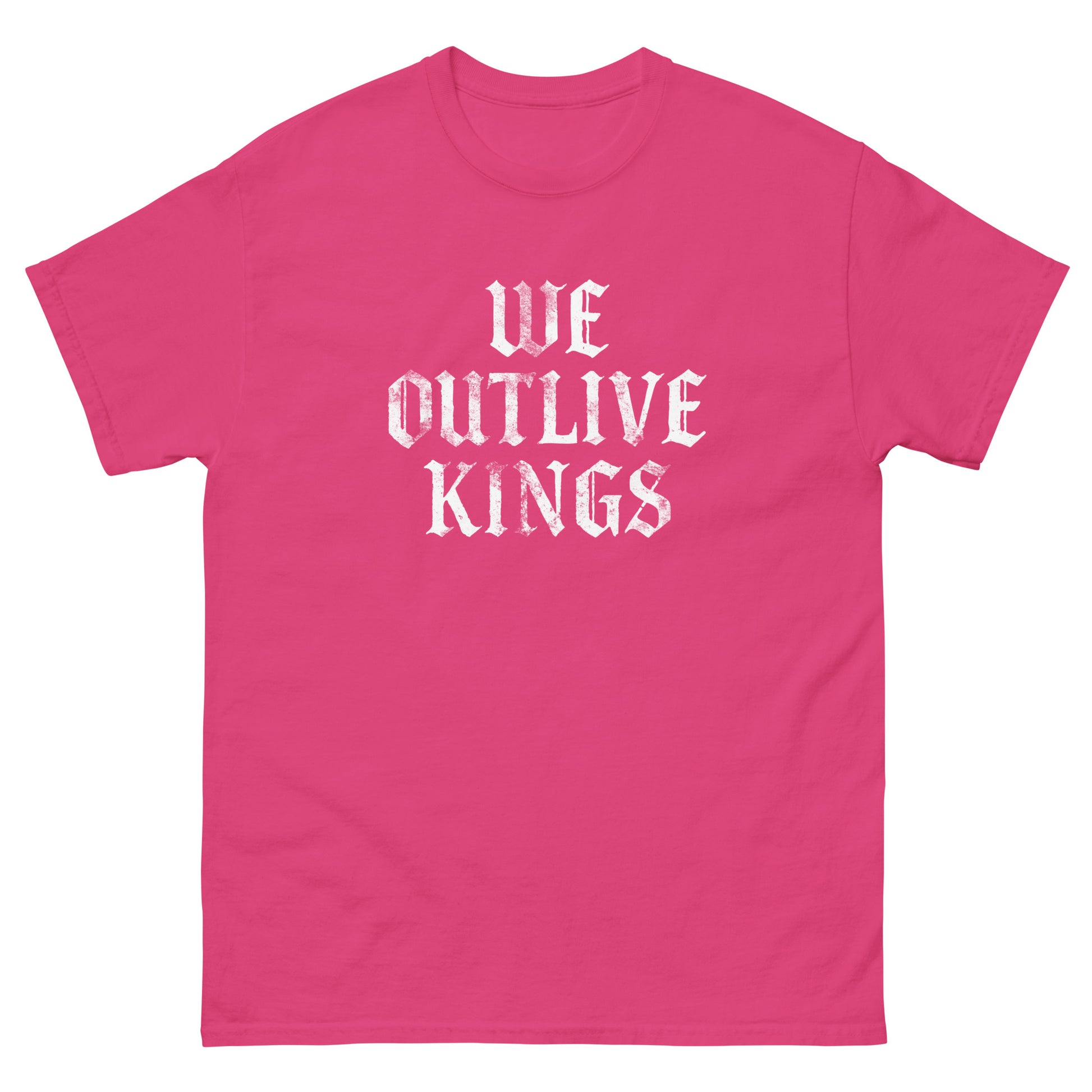 Pink unisex classic tee featuring gothic white “WE OUTLIVE KINGS” typography, bold anti-monarchy protest message for pro-democracy progressive apparel.