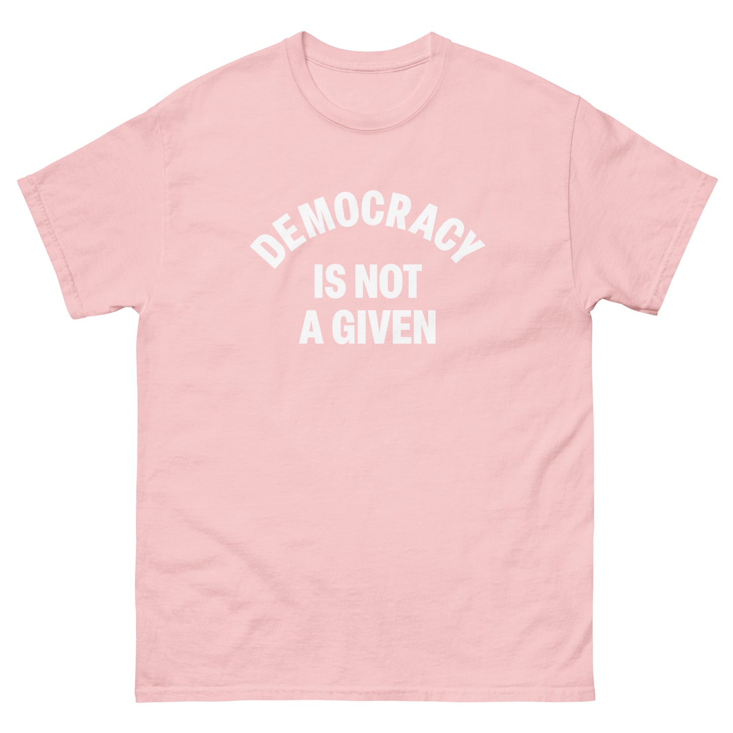 Soft pink unisex classic tee displaying centered arched democracy message in simple white lettering.