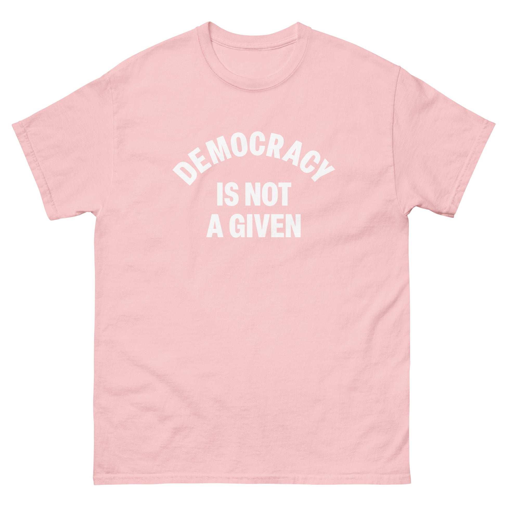 Soft pink unisex classic tee displaying centered arched democracy message in simple white lettering.