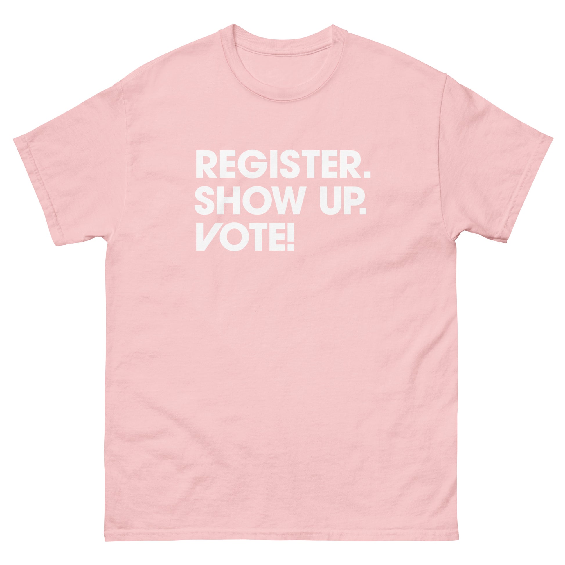 Soft pink unisex classic tee displaying civic engagement slogan encouraging registration and voting printed across chest.