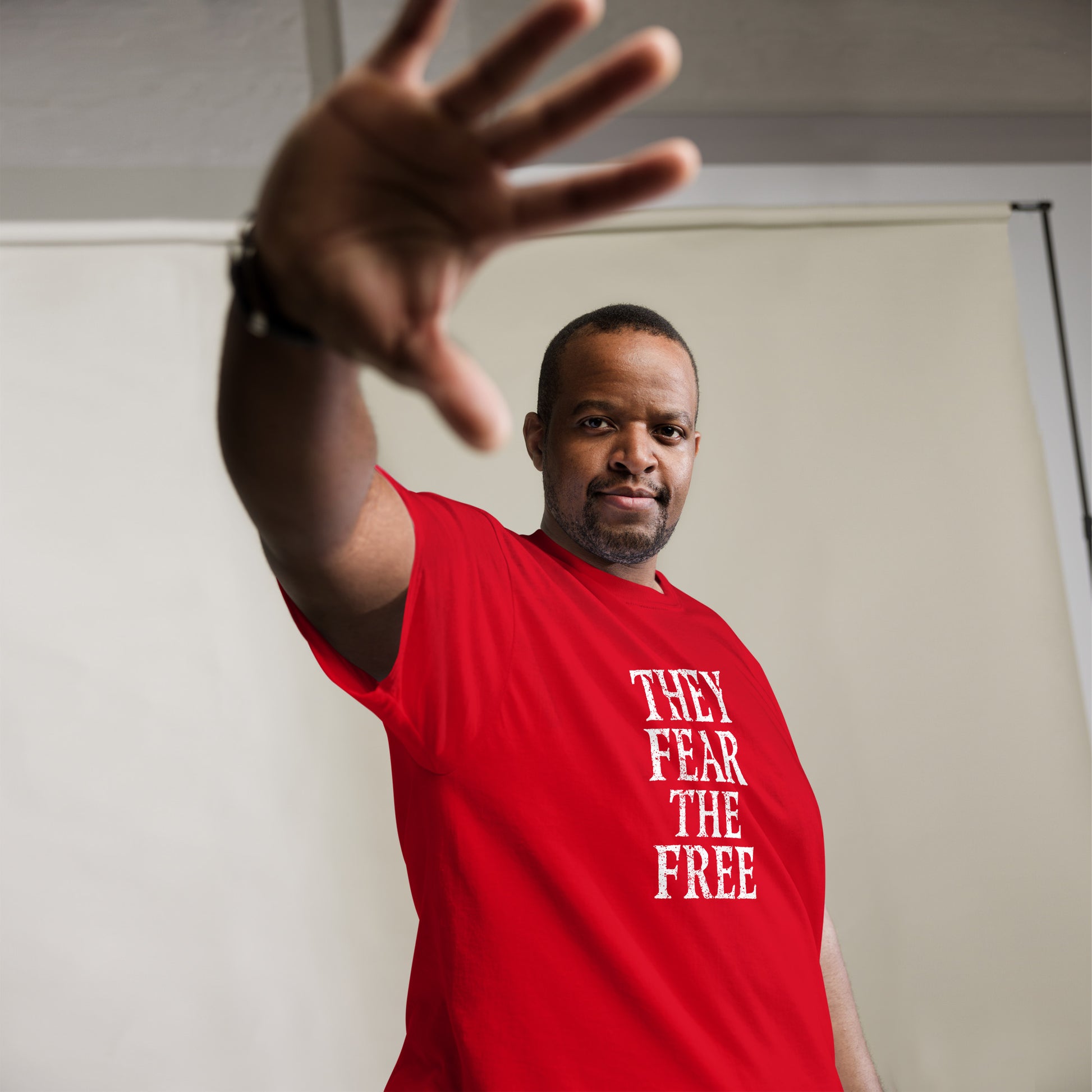 Black Anti-Kings Protester wearing the "They Fear The Free" Anti-Authoritarian Anti-Trump Unisex Classic Tee