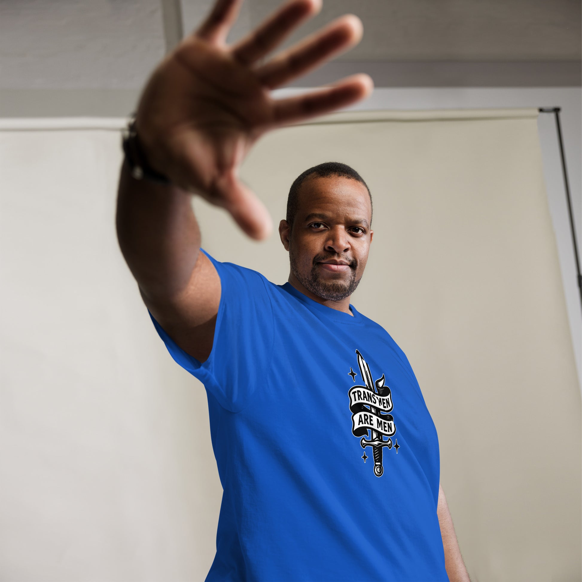 Black male trans rights advocate wearing  the "Trans Men Are Men" Trans Pride Trans Ally Unisex Classic Tee