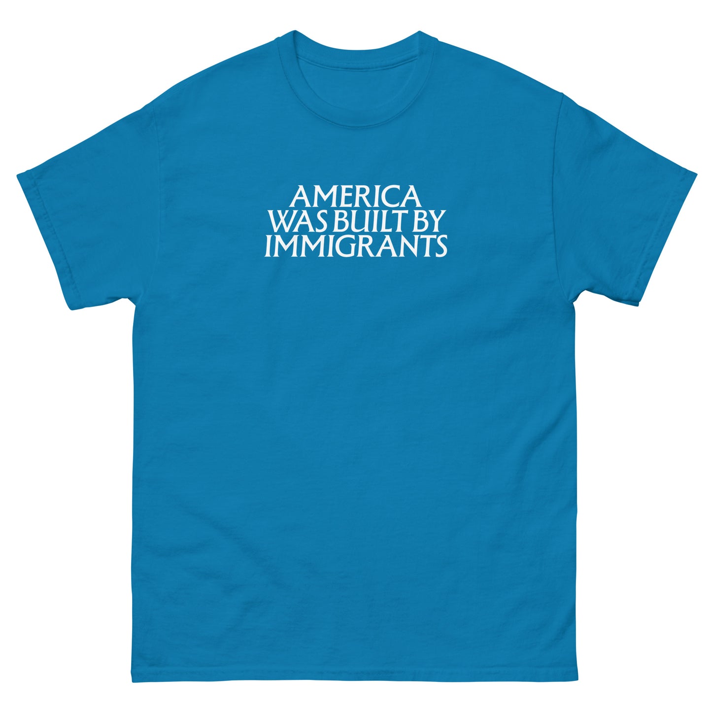 Teal unisex embroidered t-shirt with small chest text in clean serif lettering, minimalist pro-immigrant message stitched in white thread on soft cotton fabric.