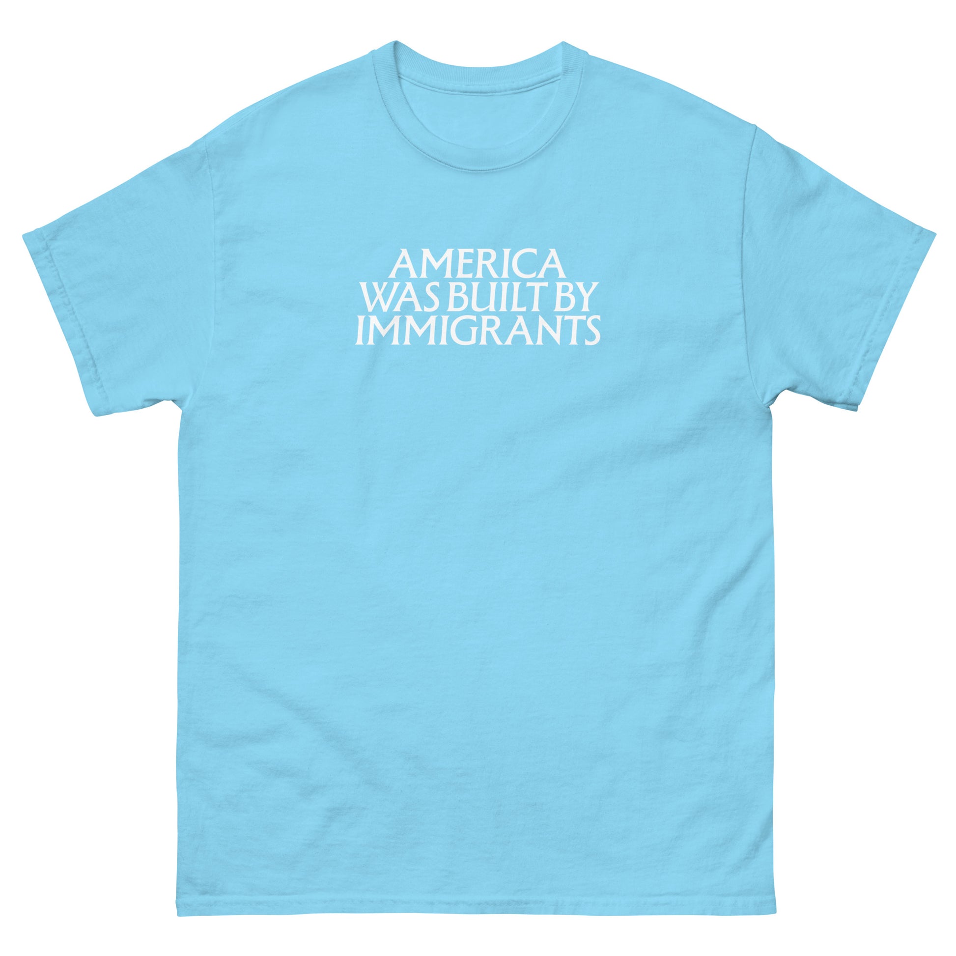 Light blue unisex embroidered t-shirt featuring subtle white chest text, minimalist typographic design with a pro-immigrant message.