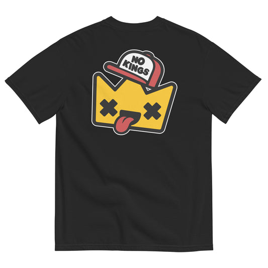 Black garment-dyed t-shirt displaying a playful “No Kings” cartoon crown with X-shaped eyes and tongue-out expression inspired by protest art and democratic values.