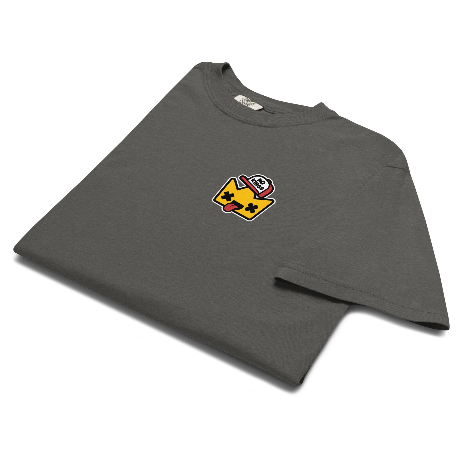 Folded Comfort Colors t-shirt featuring a small embroidered-style “No Kings” crown graphic on the chest, emphasizing the garment-dyed texture and relaxed fit.
