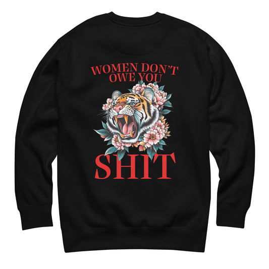 Black unisex premium sweatshirt featuring roaring tiger illustration with flowers and phrase “Women Don’t Owe You Sh*t,” bold feminist activist apparel from Blue Wave USA.