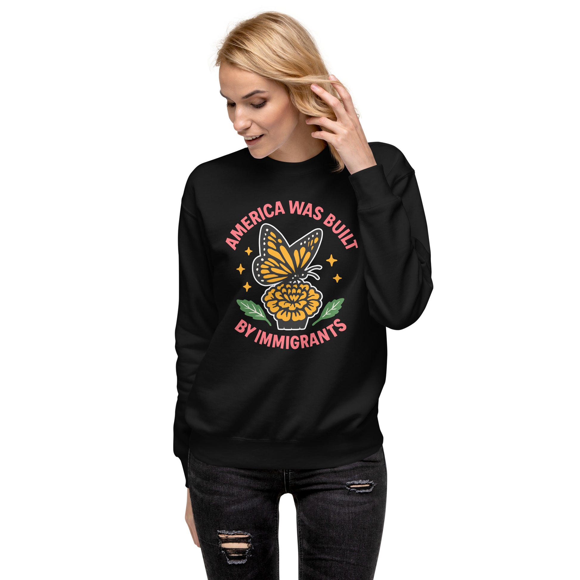 Model wearing “America Was Built by Immigrants” sweatshirt with monarch butterfly design, Blue Wave USA progressive apparel for immigrant rights.