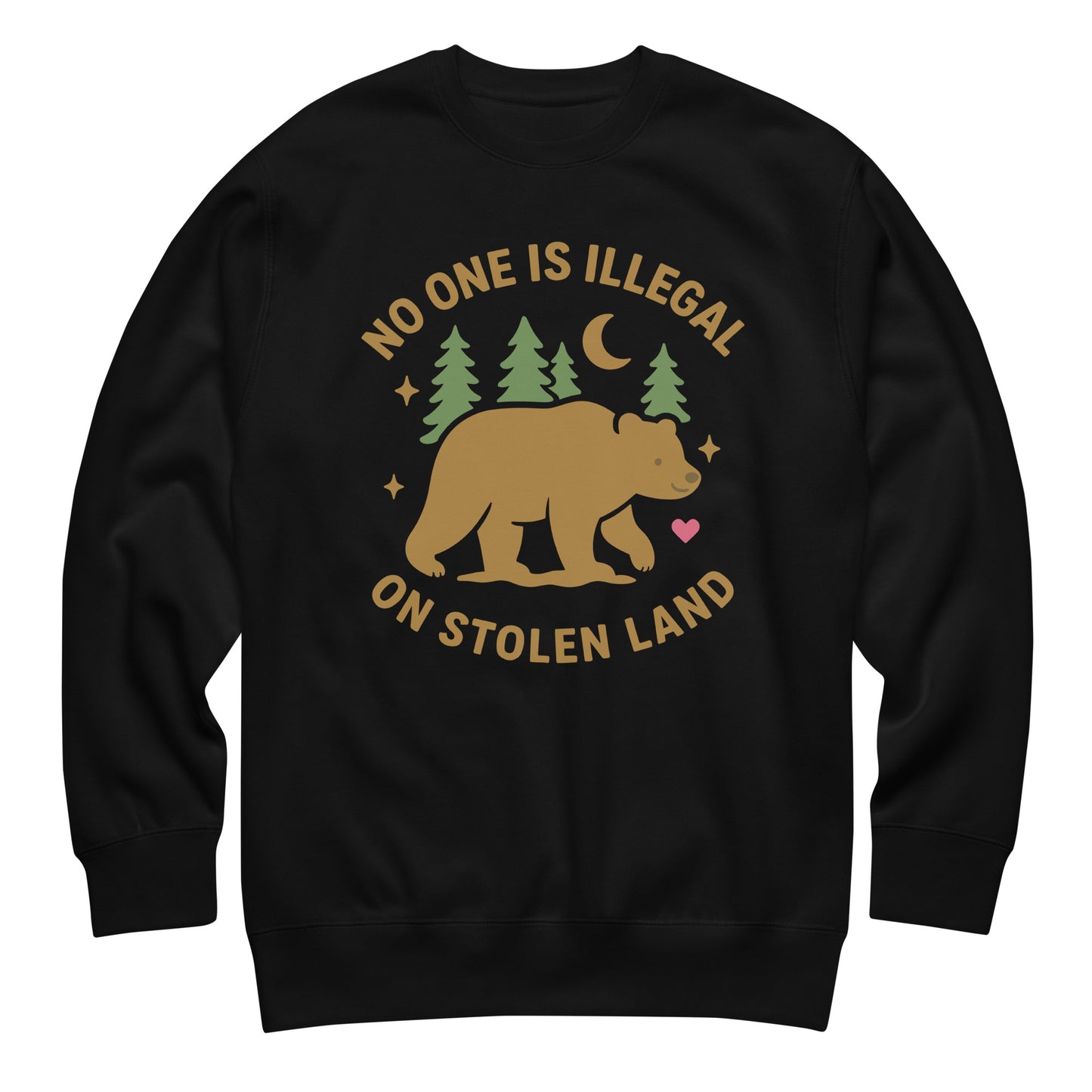 Black unisex premium sweatshirt featuring a tan bear, pine trees, moon, stars, and a small heart beneath the message “NO ONE IS ILLEGAL ON STOLEN LAND,” printed in warm earthy tones.