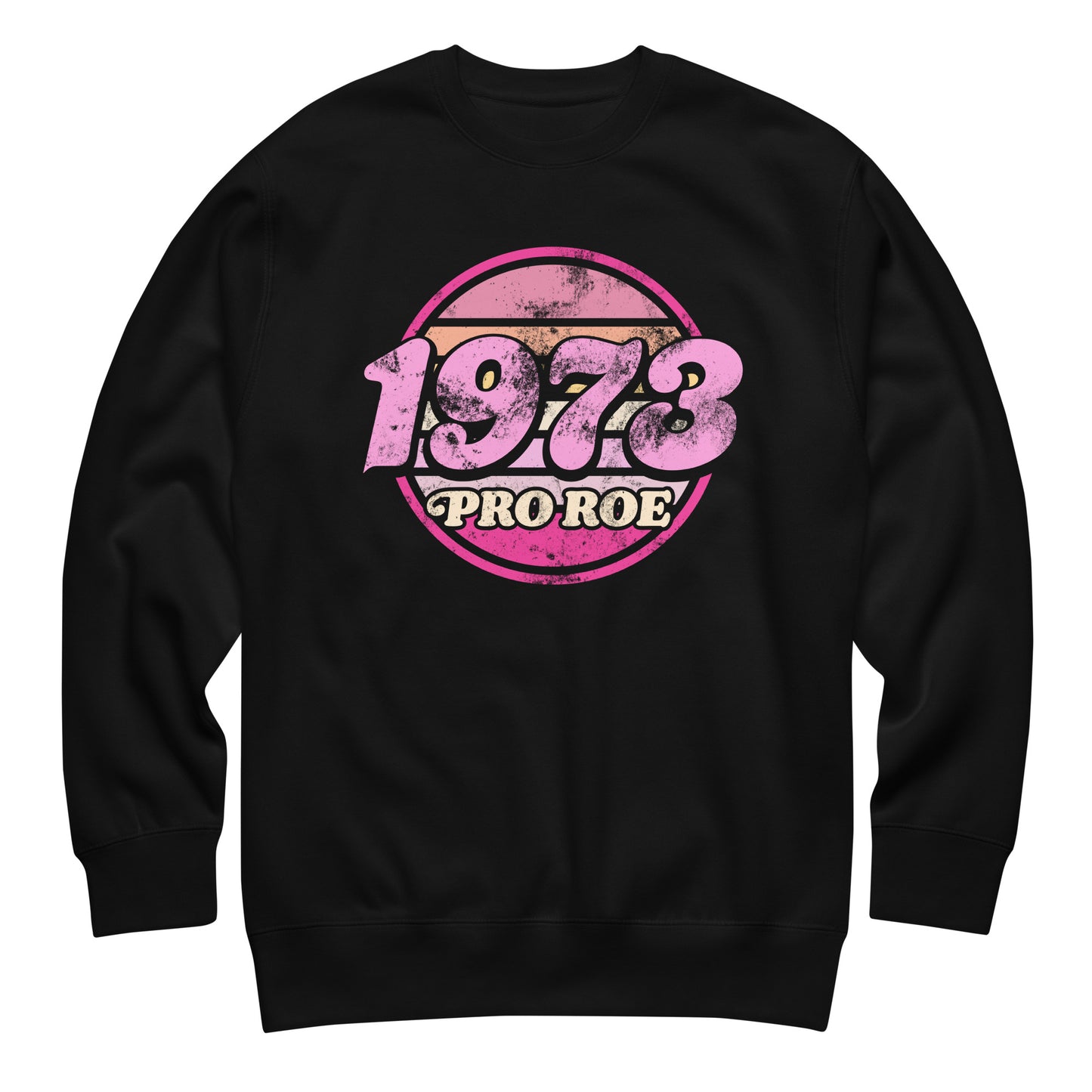 Black unisex premium sweatshirt featuring a distressed retro circular badge in pink and cream reading “1973 PRO ROE,” vintage reproductive freedom design centered on a solid black fleece.