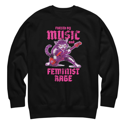 Black unisex premium sweatshirt featuring a punk rock cat playing electric guitar with bold gothic lettering reading “FUELED BY MUSIC AND FEMINIST RAGE,” vibrant purple and pink graphic centered.