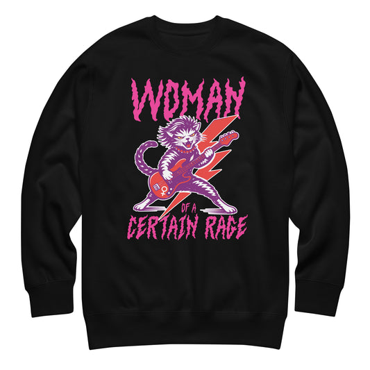 Black unisex premium sweatshirt featuring a feminist punk rock cat playing electric guitar with bold distressed lettering reading “WOMAN OF A CERTAIN RAGE,” vibrant pink and purple graphic centered.
