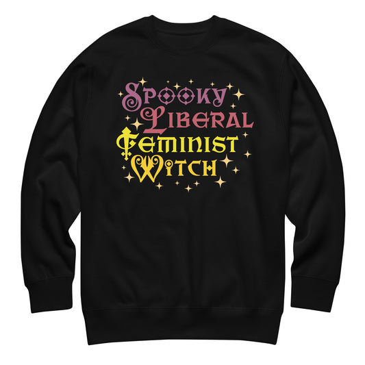 Unisex premium sweatshirt featuring stacked whimsical typography with star accents in pink and yellow, playful witchy style, centered layout, printed message “SPOOKY LIBERAL FEMINIST WITCH,” black fabric.