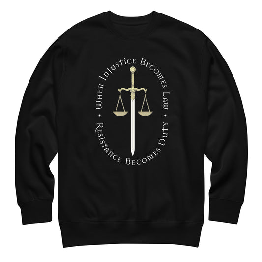 Black unisex premium sweatshirt featuring Sword of Justice and scales illustration with circular typography reading “WHEN INJUSTICE BECOMES LAW RESISTANCE BECOMES DUTY.”