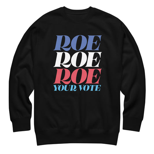 Black unisex premium sweatshirt featuring stacked red, white, and blue typography reading “Roe Roe Roe Your Vote,” reproductive rights activist apparel from Blue Wave USA.