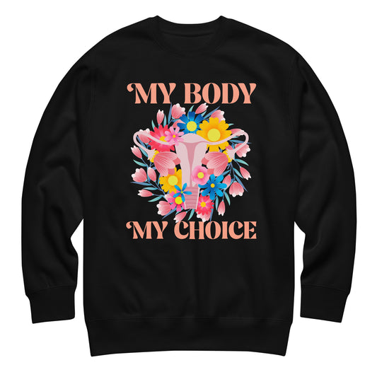 Black unisex premium sweatshirt featuring floral uterus illustration with colorful flowers and text “MY BODY MY CHOICE,” reproductive freedom activist apparel from Blue Wave USA.