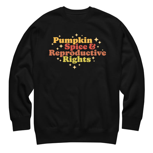 Black unisex premium sweatshirt featuring retro fall typography reading “Pumpkin Spice & Reproductive Rights,” pro-choice activist apparel from Blue Wave USA.