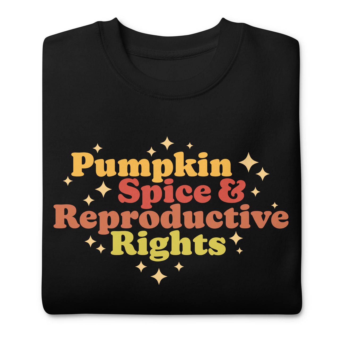 Folded black unisex premium sweatshirt featuring retro typography reading “Pumpkin Spice & Reproductive Rights,” reproductive freedom activist sweatshirt.